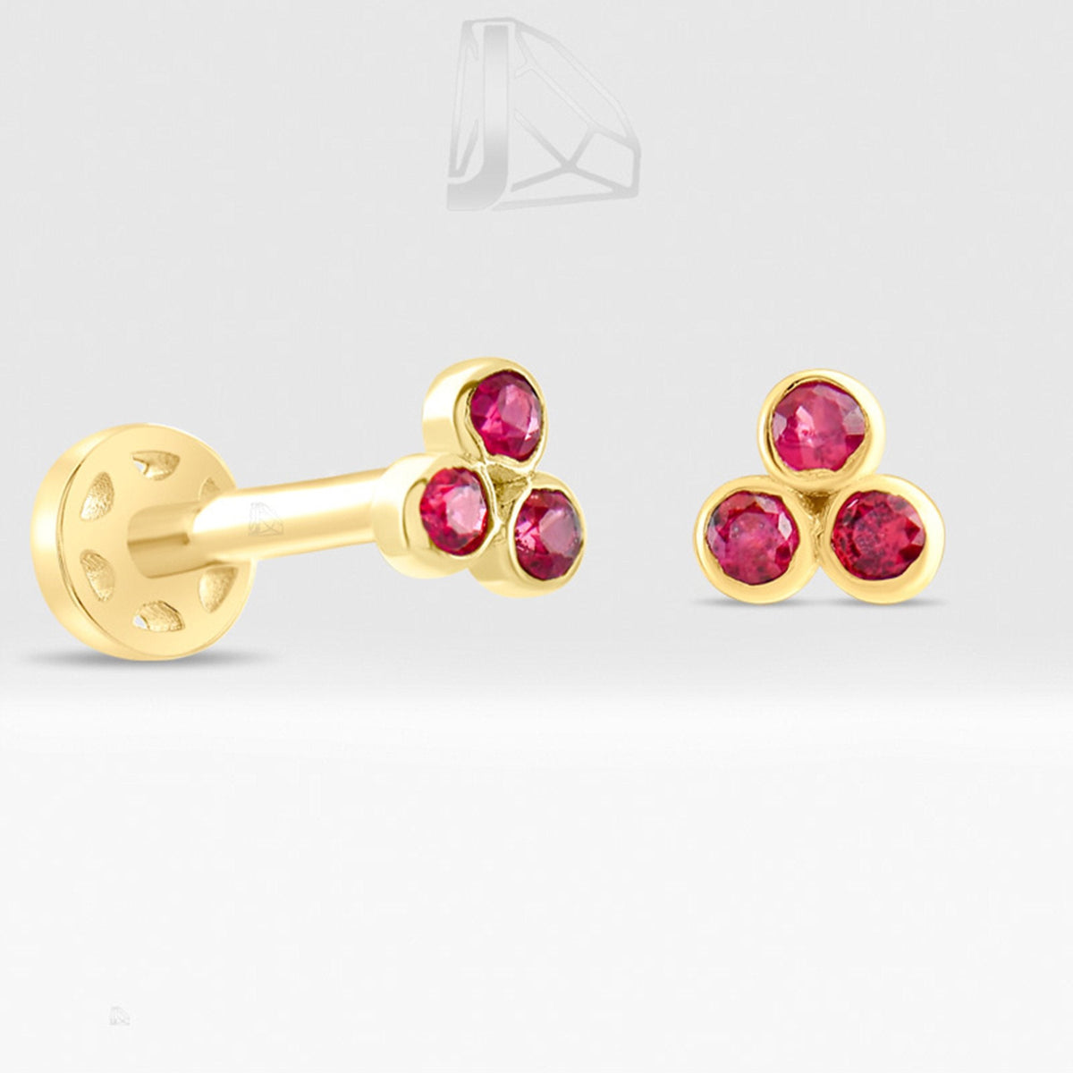 0.09 Carat Three-Stone Ruby Piercing · Yellow Gold